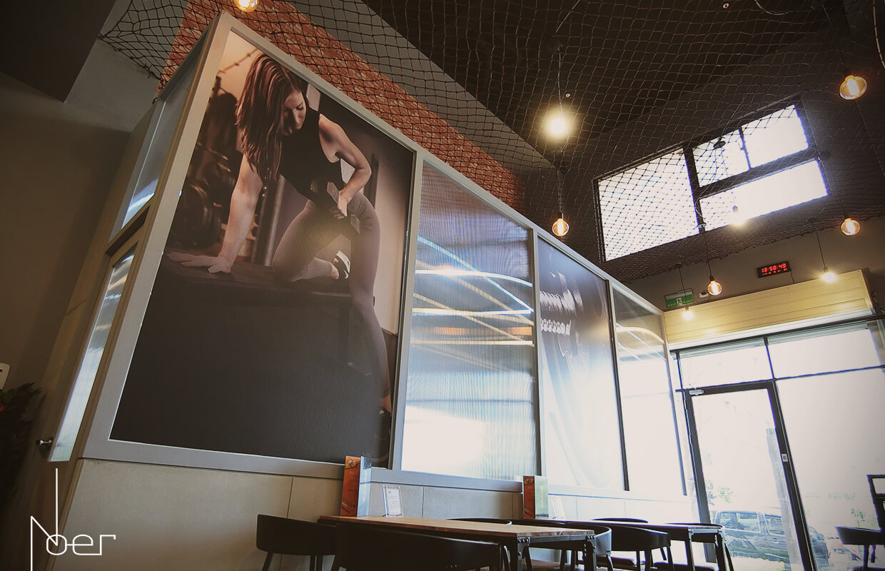 利用透明中空板分隔用餐區與健身區，兼具採光與造型。